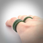 This is a hand carved jade ring. These are lovely British Columbian jade rings which are nice, solid little works of art. We ship these worldwide for free and are happy to answer any questions that you may have about these or other products on our website.